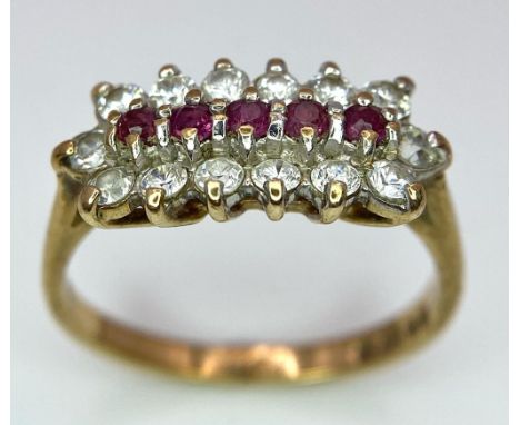 A Vintage 9K Yellow Gold Ruby and Diamond Ring. Five rubies with a twelve diamond surround. Size J. 2.15g total weight. 