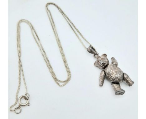 A vintage 925 silver articulated bear pendant on silver chain. Total weight 9.8G. Total length 45cm. 