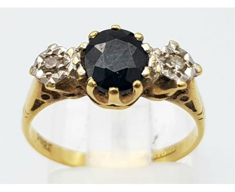 A Vintage 18K Yellow Gold, Diamond and Sapphire Ring. Central round cut sapphire with a diamond either side. Size L. 2.88g to