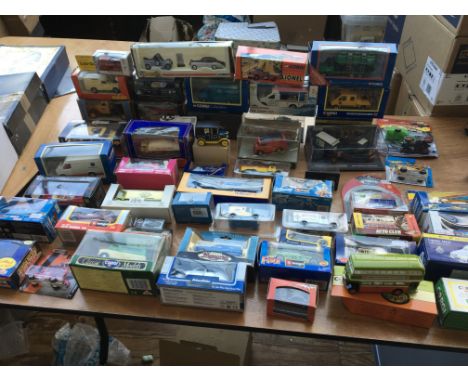 A collection of boxed diecast vehicles including Corgi, Burago etc