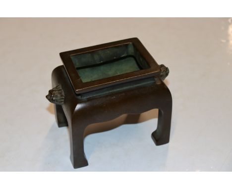 A Chinese four legged bronze censer of rectangular form, seal mark to base, 10.5cm high 