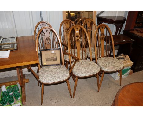 A set of six swan back Ercol dining chairs comprising of two carvers and four standards 