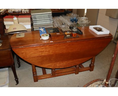 A large cherry wood gate leg dining table