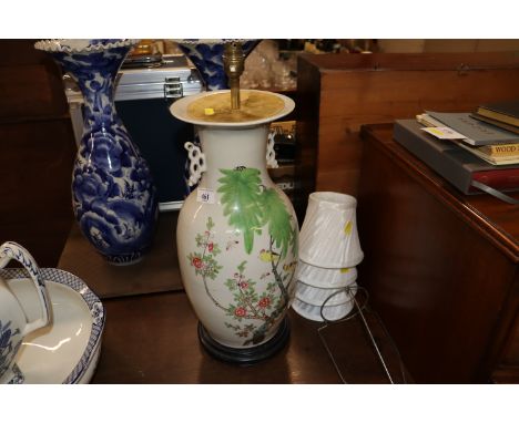 An Oriental decorated converted table lamp decorated with bird amongst foliage 