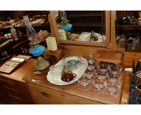 An oil lamp with blue glass reservoir; a meat plate; table glassware; marbles etc.