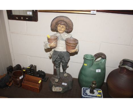 A terracotta Goldscheider style figure of a young boy carrying flower pots AF
