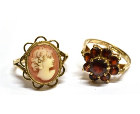 TWO 9 CARAT GOLD DRESS RINGS  comprising a small oval cameo set, ring size K and a garnet flower head cluster, ring size J, t