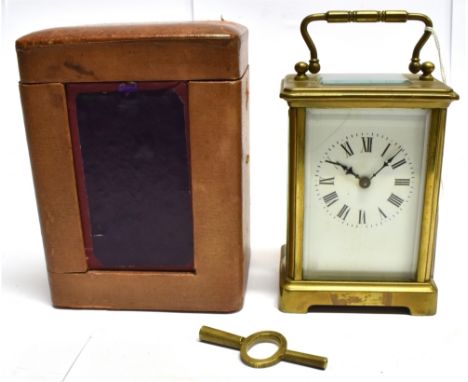A BRASS CASED CARRIAGE CLOCK  the enamel dial with Roman numerals, complete with carrying case