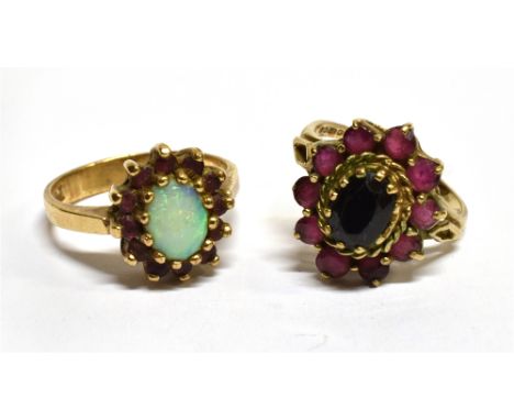 TWO 9 CARAT GOLD DRESS RINGS  comprising an opal and synthetic ruby oval cluster and a red stone oval cluster, ring sizes K ½