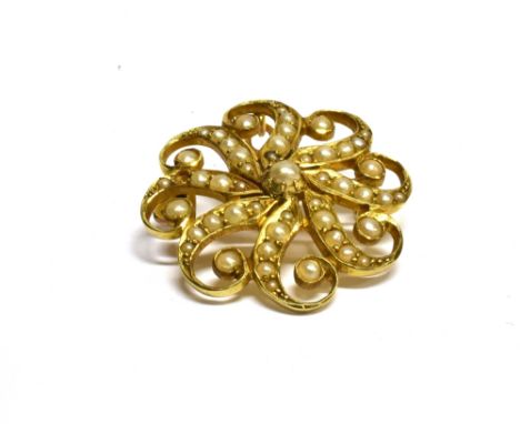 AN EDWARDIAN 15 CARAT GOLD SEED PEARL SET BROOCH circular swirl design, brooch pin and pendant loop to reverse, gross weight 
