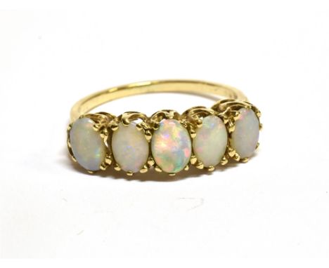 AN OPAL FIVE STONE 9 CARAT GOLD RING  five cabochon opals claw set to a yellow gold shank, ring size N, gross weight 2.6grams