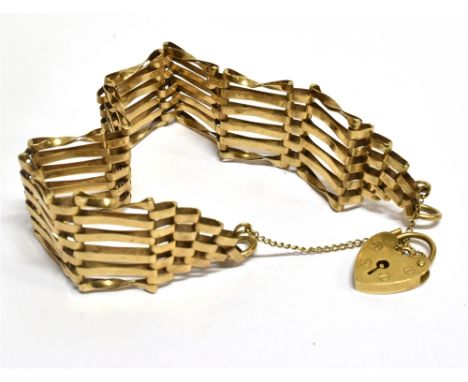 A 9 CARAT GOLD GATE BRACELET  with padlock fastener and safety chain, the 6 bar gate bracelet, hallmarked 9 carat gold (moder