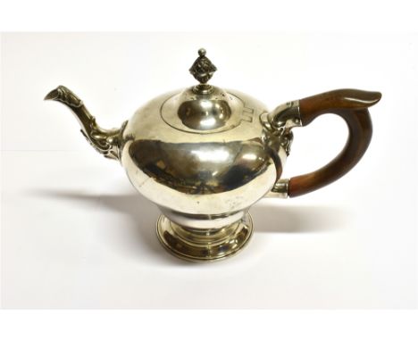 A GEORGIAN SILVER SMALL TEAPOT of plain pear-shaped design, applied scroll decoration to spout, pineapple finial to lid, meas