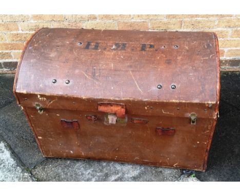 A LEATHER BOUND DOME TOP CANVAS SHIPPING TRUNK  initialled 'HMP' to top, 82cm wide 54cm deep 64cm high