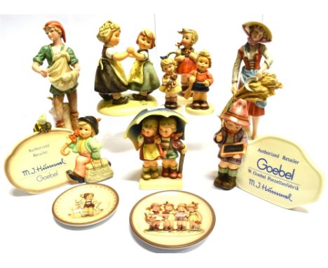 A COLLECTION OF HUMMEL/GOEBEL FIGURES  including a pair modelled as male and female peasants 21cm high, a pair of retailers d
