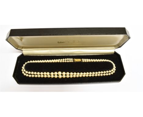 A TWO ROW CULTURED PEARL NECKLACE  With a 9 carat gold cushion shaped clasp with radiating pattern, the cultured pearl head g