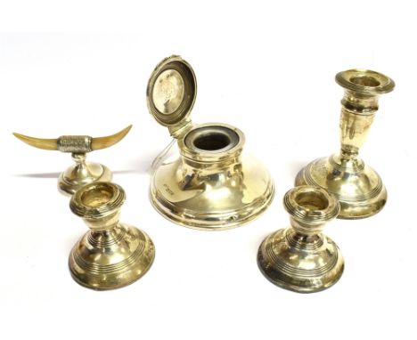A SILVER CAPSTON INKWELL a small silver candlestick, a pair of dwarf candlesticks (as found) and a silver horn shaped ring ho