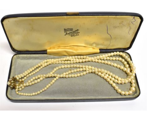 A THREE ROW CULTURED PEARL NECKLACE  With a 9 carat gold cultured pearl cluster snap clasp, graduating pearl beads, 5mm to 4m