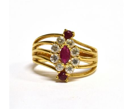 AN 18 CARAT GOLD RUBY AND WHITE STONE RING the oval cluster to open twist wirework shoulders, ring size M, gross weight 4.6 g