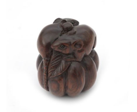  A carved wooden netsuke depicting two rats on a pumpkin, signed. 20th century 