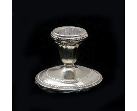  A silver candlestick on a round foot with a pearl rim. With traces of use and slightly loosened filled foot. Germany, grade 