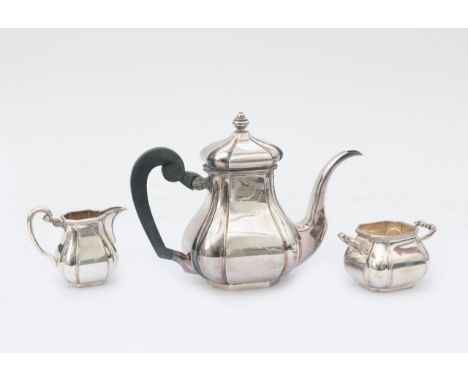  A three piece 835 silver tea service, comprising: teapot with wooden scroll handle, two handled sugar basin and cream jug, d