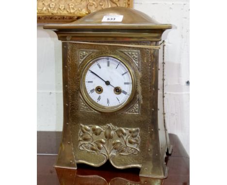 An Arts &amp; Crafts brass cased mantel clock with French movement, 13"