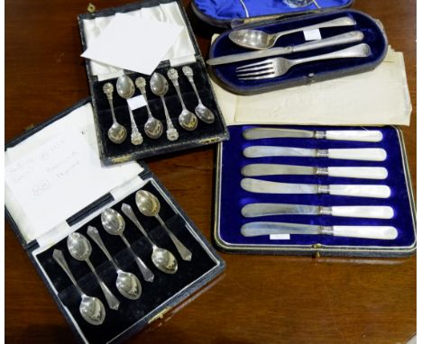 A set of silver thistle top coffee spoons, Birmingham 1954, cased; a similar dog nose set,   Birmingham 1954, a 3 piece beade