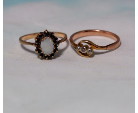 An early 20th century gold dress ring set 3 small diamonds; another set opal and garnets