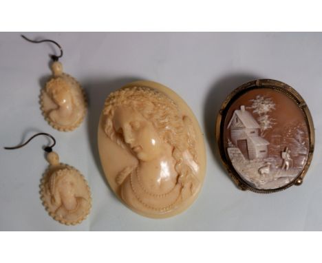 A Victorian ivory oval brooch carved in relief with head and shoulder portrait of a young woman; a pair of matching earrings;