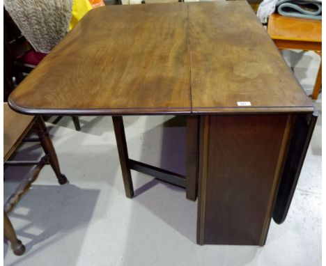 An 18th century mahogany drop leaf dining table with double gate leg