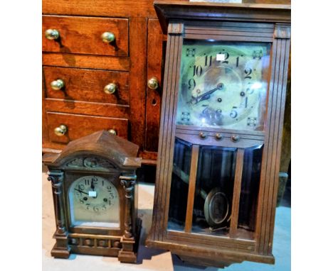 An Edwardian oak cased striking mantel clock; a 1930's oak cased wall clock