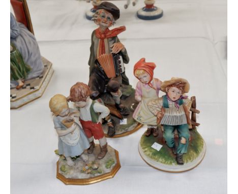 A Capodimonte group:  2 children with flowers, height 7½"; another:  2 children with accordion (girl's arm a.f.)
