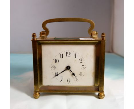 An Art Nouveau brass cased square enamel dial carriage clock with French movement