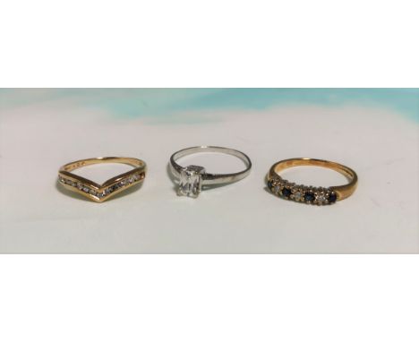 A 9 carat hallmarked gold 7 stone ring set alternating diamonds and sapphire coloured stones; a 9 carat hallmarked gold wishb