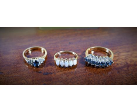 A gold dress ring set with five oval opals, stamped 375 and two gilt dress rings