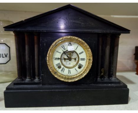 An architectural slate mantel clock with American striking movement and visible escapement