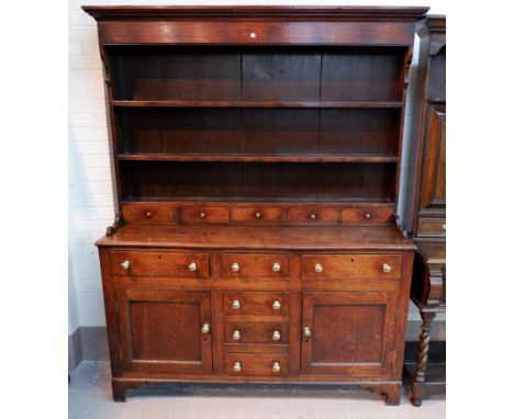 An 18th century Welsh dresser with raised back, moulded cornice, 2 shelves over 5 small drawers, the base with 3 frieze and 3