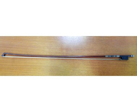 A violin bow by H C SILVESTRE, Paris with silver mounts (2 small elements of mother of pearl missing), 29.25", weight 64.3gm