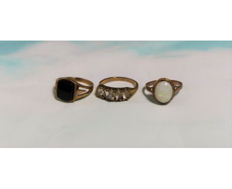 Three 9 carat hallmarked gold dress rings:  one set opal coloured stone; one set black stone; one set 5 opaline stones, 7.7 g