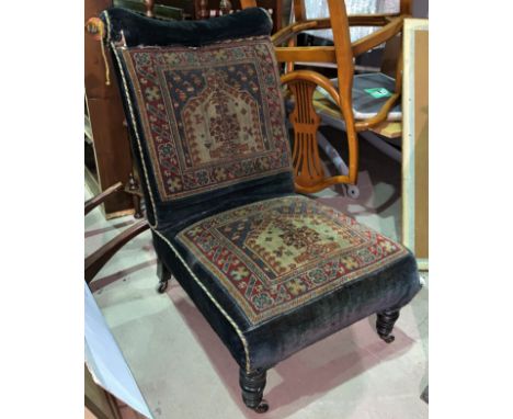 A late 19th early 20th century tapestry nursing chair with turned legs