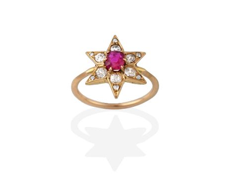 A Ruby and Diamond Cluster Ring, in a star formation, the cushion cut ruby in a yellow claw setting, to six old cut and rose 