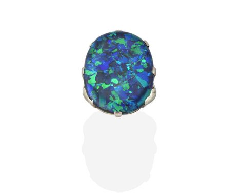A Black Boulder Opal Ring, the oval cabochon black boulder opal in a white claw setting, to a tapered shoulder plain polished