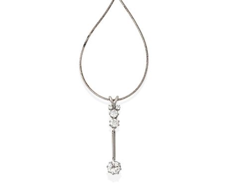 A Diamond Pendant on Chain, a T-shaped formation of round brilliant cut diamonds suspends a larger round brilliant cut diamon