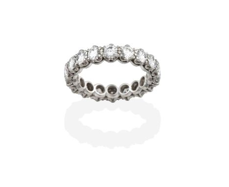 A Diamond Eternity Ring, the eighteen round brilliant cut diamonds in white claw settings, total estimated diamond weight 2.7