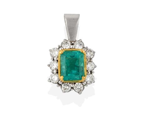 An Emerald and Diamond Cluster Pendant, the emerald-cut emerald in a yellow four claw setting, within a border of round brill