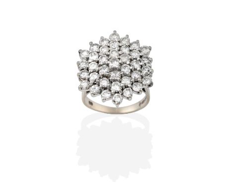 An 18 Carat White Gold Diamond Cluster Ring, the hexagonal motif set throughout with round brilliant cut diamonds, in claw se