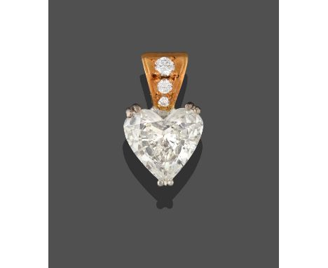 An 18 Carat Gold Diamond Pendant, the heart shaped diamond in a white double claw setting, suspended from a yellow bale inset