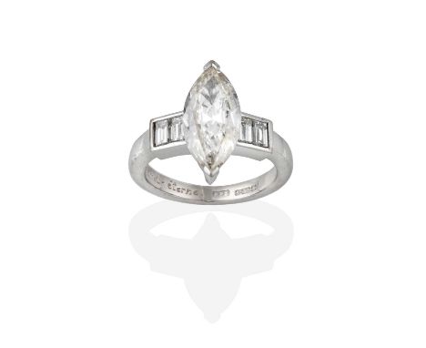 An 18 Carat White Gold Diamond Ring, the central marquise cut diamond in a claw setting, flanked by pairs of baguette cut dia