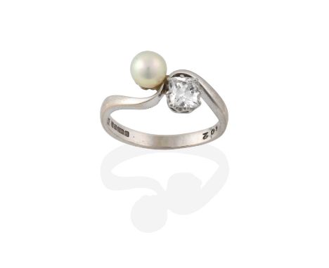 An 18 Carat White Gold Pearl and Diamond Twist Ring, the pearl set diagonally to a cushion cut diamond, in claw settings, to 